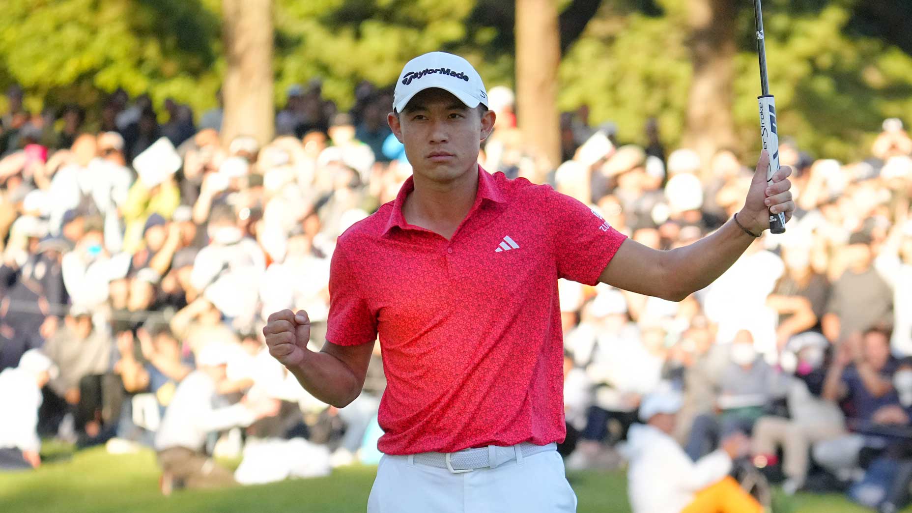 Collin Morikawa celebrates winning the Zozo Championship.