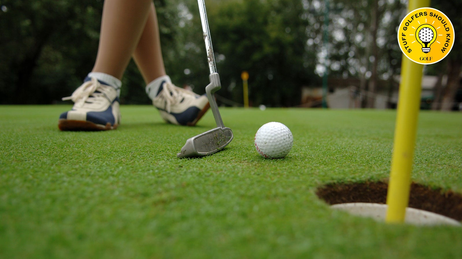 beginner golfer on putting green
