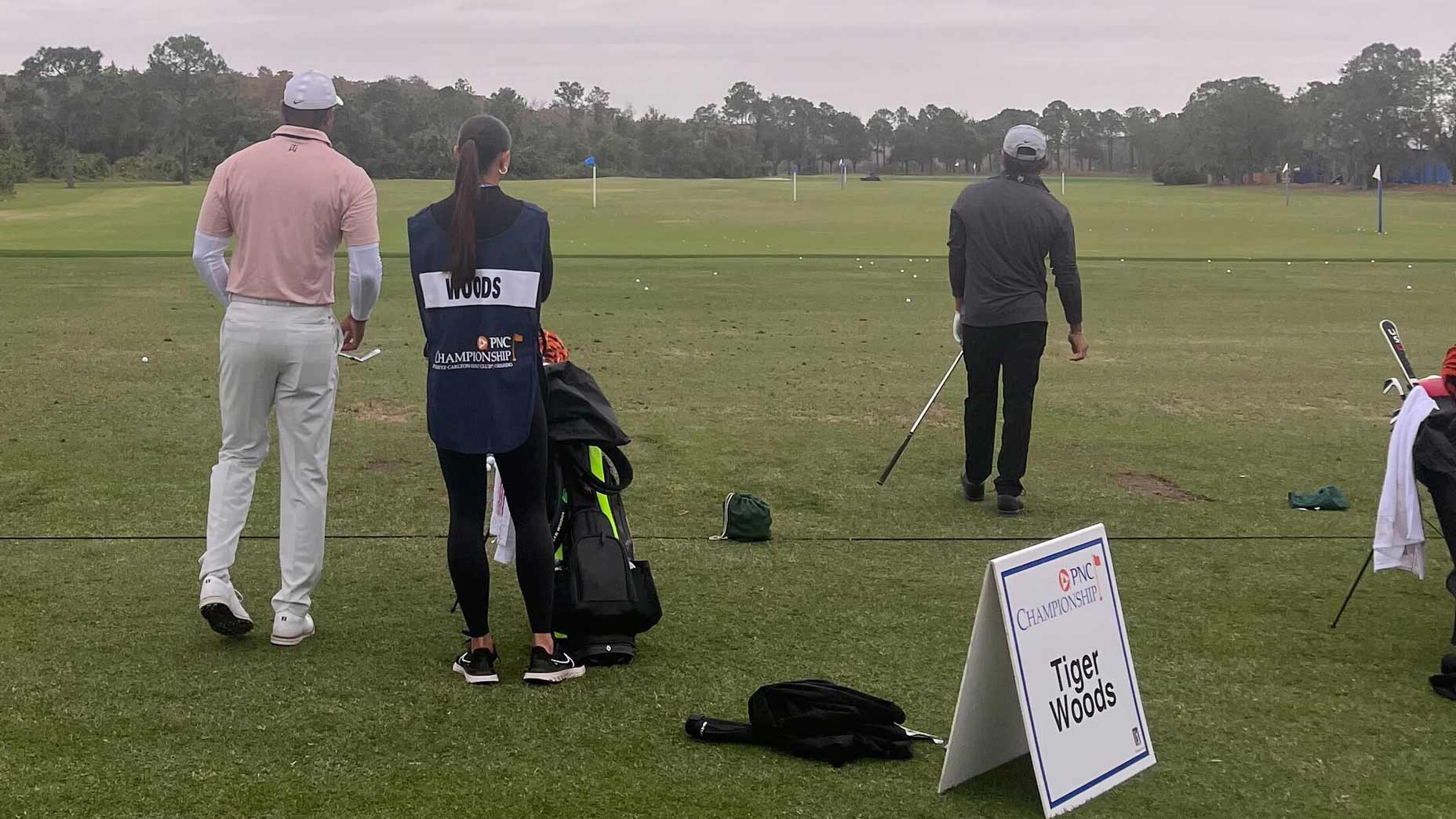Tiger, Sam and Charlie Woods warm-up before the first round of the PNC Championship.