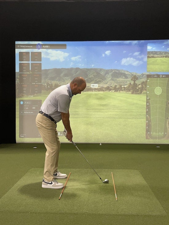 An indoor golf drill focusing on alignment and posture