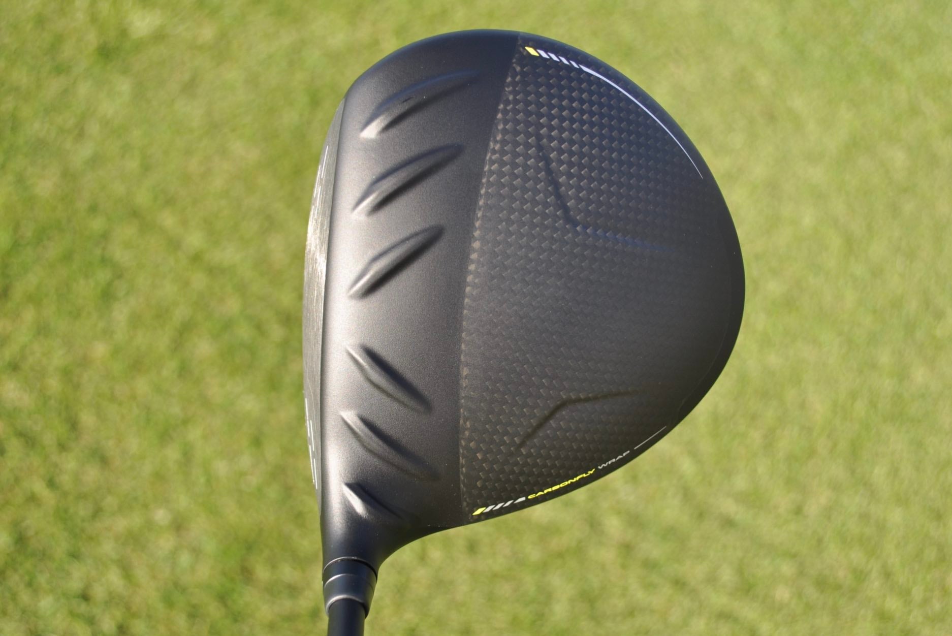 A Ping G430 MAX 10K driver at address seen on a golf course