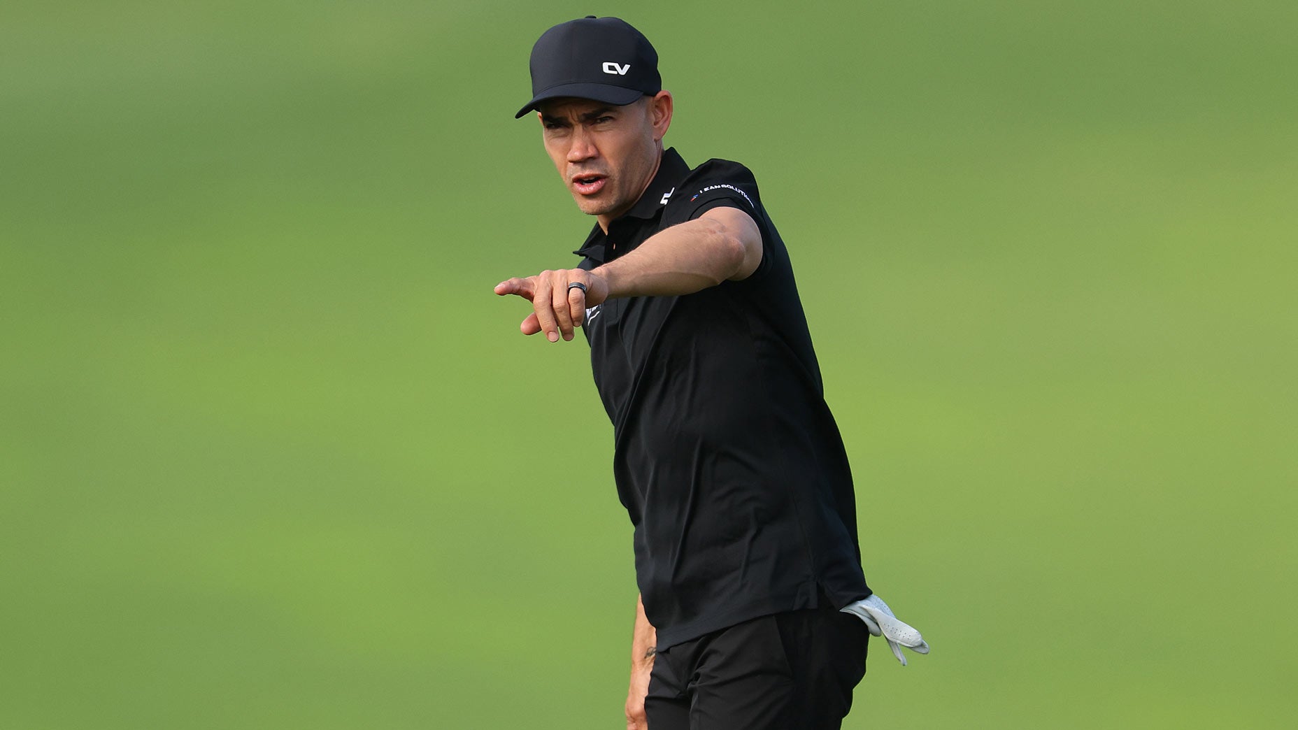 PGA Tour pro Camilo Villegas points on green during practice at 2024 Sentry