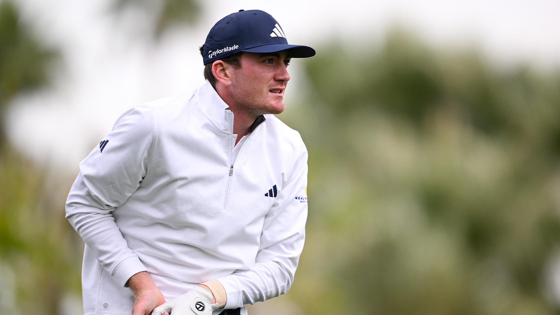 nick dunlap hits driver at American Express in white shirt