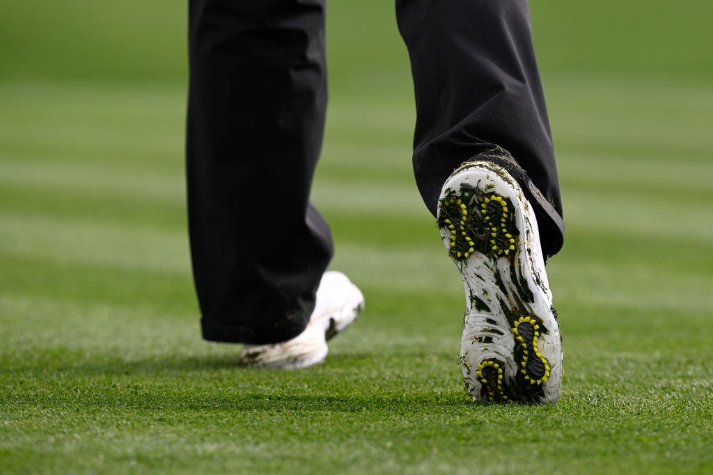 White Puma golf shoes with yellow spikes
