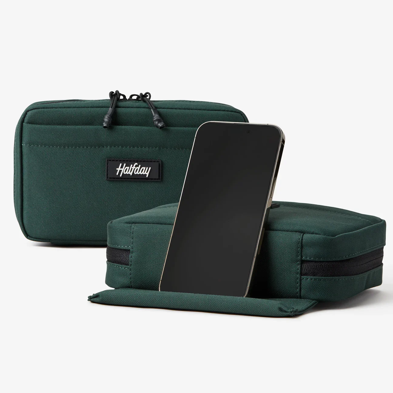 Halfday's 'Sidekick Tech Kit' in their hunter green color. This tech bag doubles as a phone stand and features a convenient charging pocket.