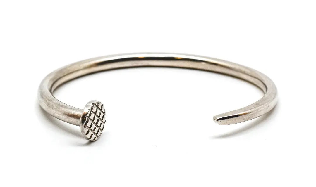 The Omega Cuff for the individual whose passion for authenticity and excellence shines through. The men's Craftsman bracelet is available in Sterling Silver and Gold precious metal finishes, and is crafted in the form of a nail —customizable to be a fit as the finishing touch on your personal style.