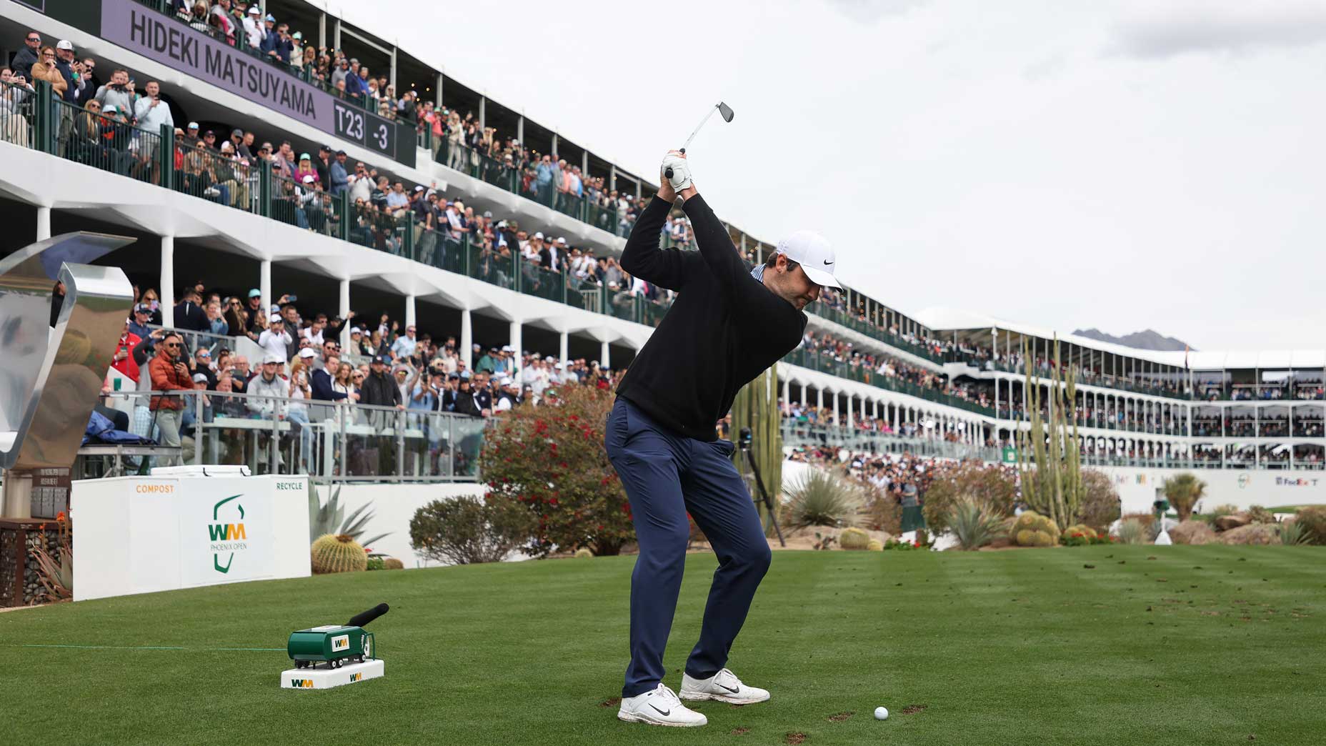 Scottie Scheffler hits a tee shot at the "Stadium hole."
