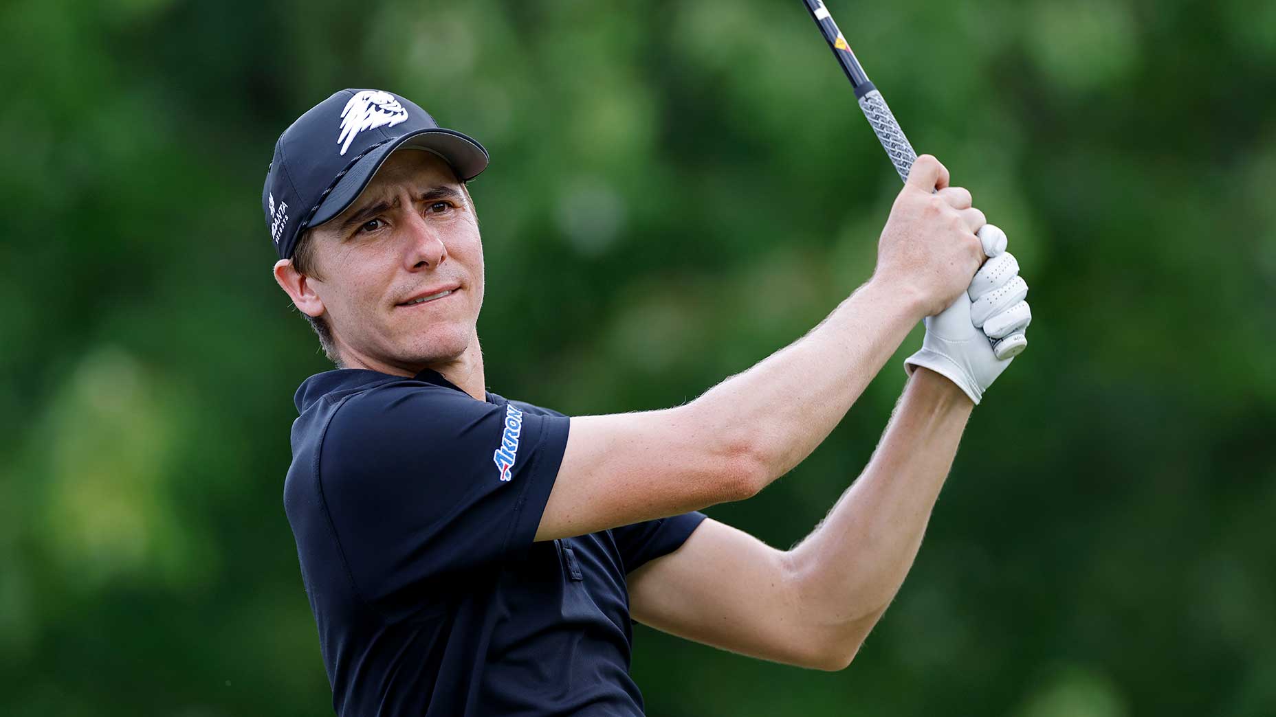 carlos ortiz swings iron at LIV Golf event