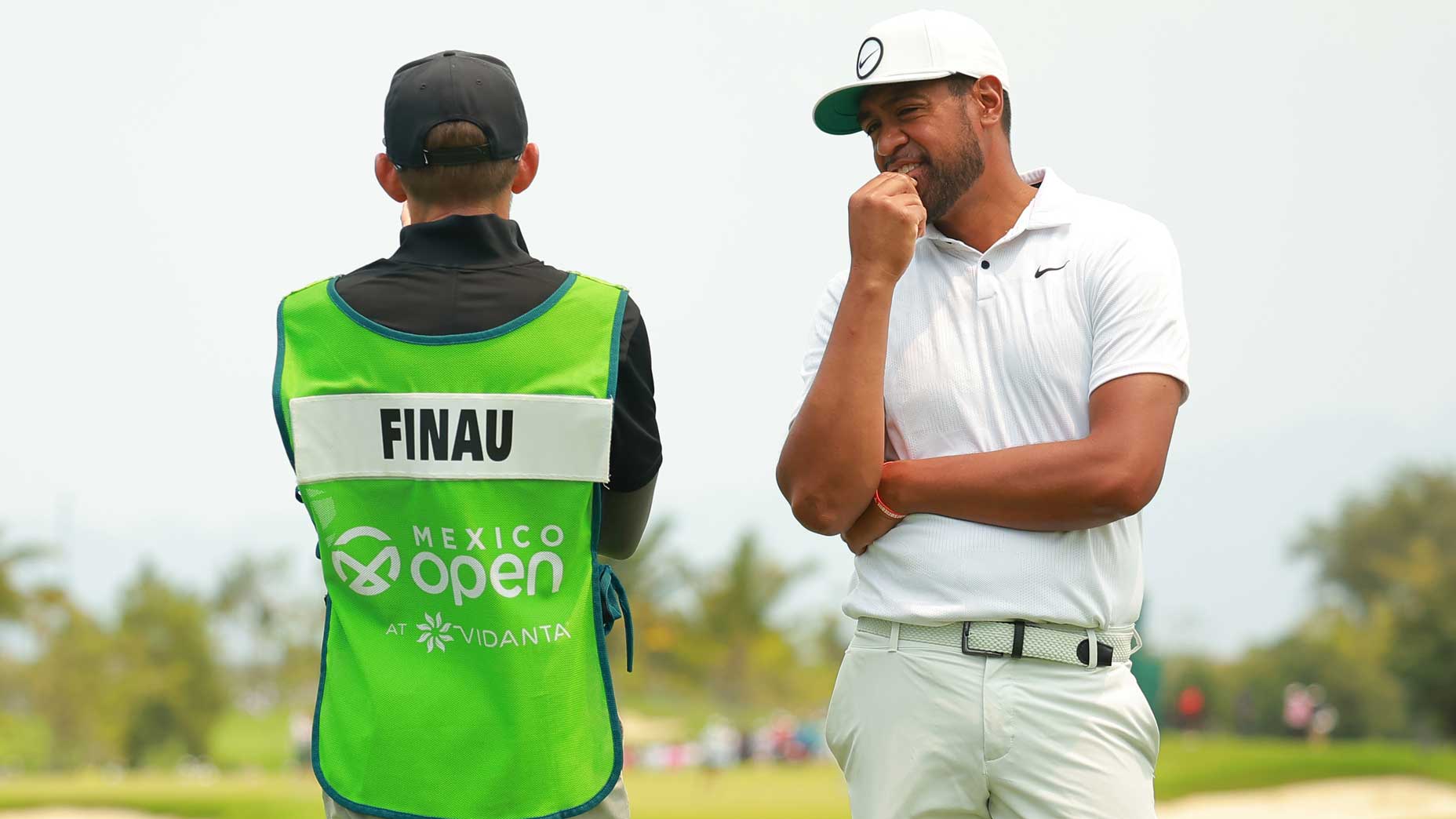 Pro golfer Tony Finau and his caddie talk at the 2023 Mexico Open at Vidanata