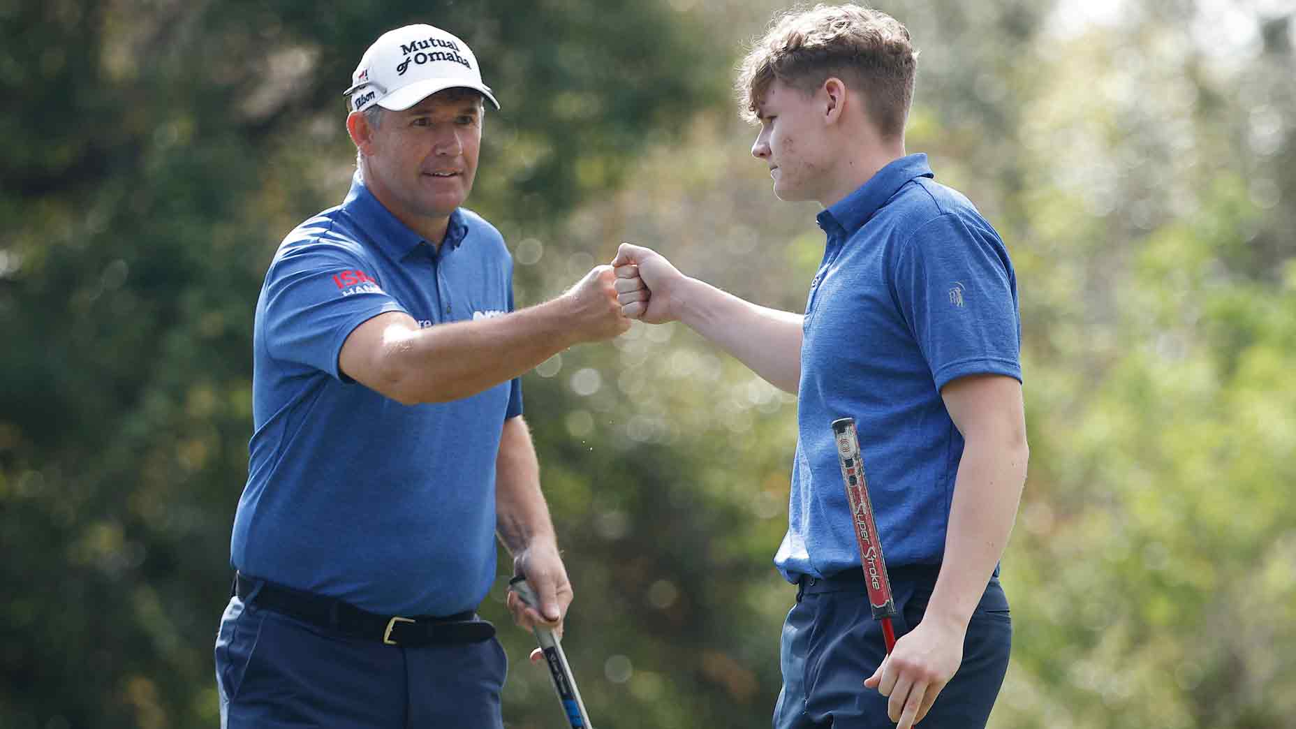 Padraig Harrington of Ireland and son, Ciaran Harrington, react on the 13th green after a birdie during the final round of the PNC Championship at The Ritz-Carlton Golf Club on December 17, 2023