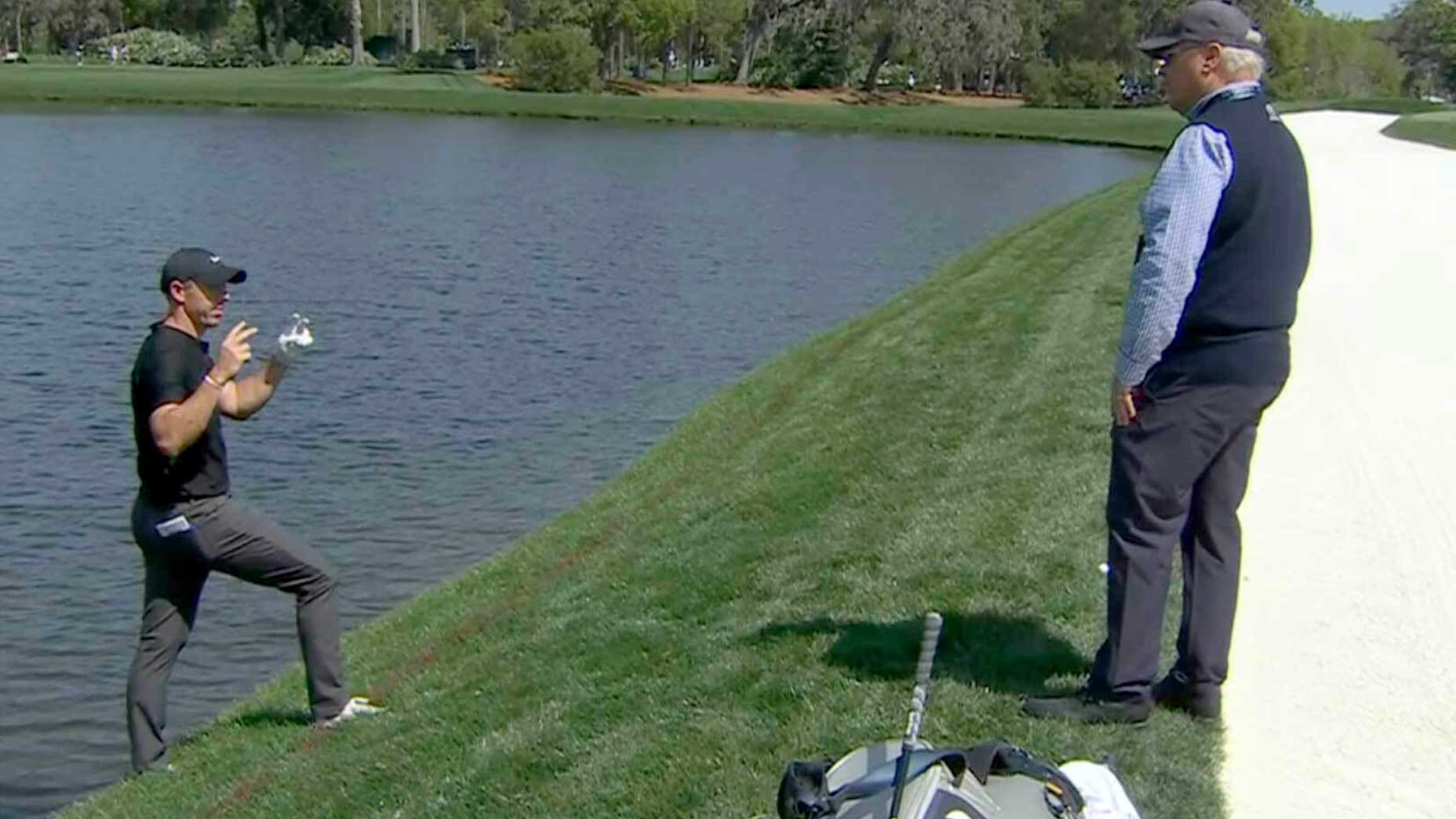 rory mcilroy talks to a rules official on thursday