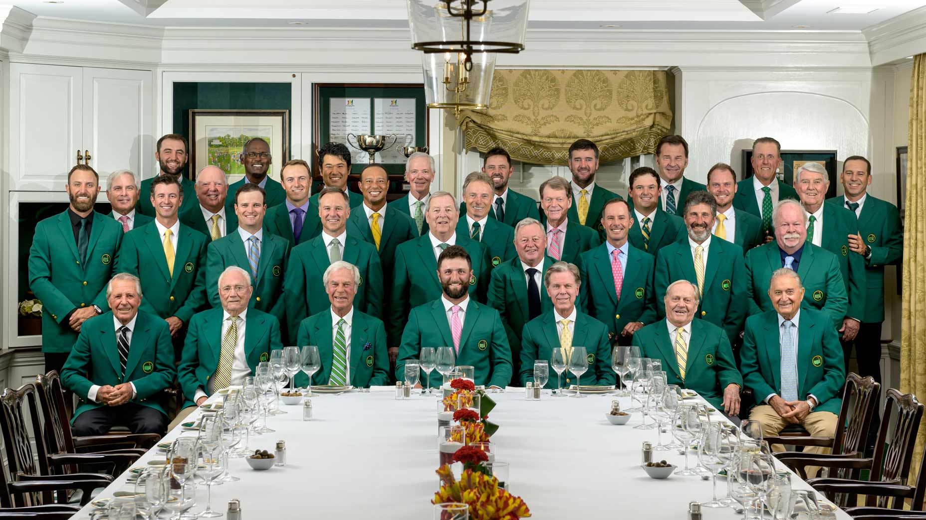 Past Masters champions pose with Jon Rahm in green jackets at the 2024 Masters Champions Dinner