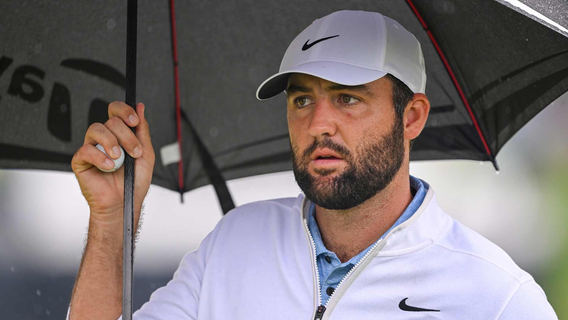 Close-up of Scottie Scheffler holding umbrella at 2024 PGA Championship