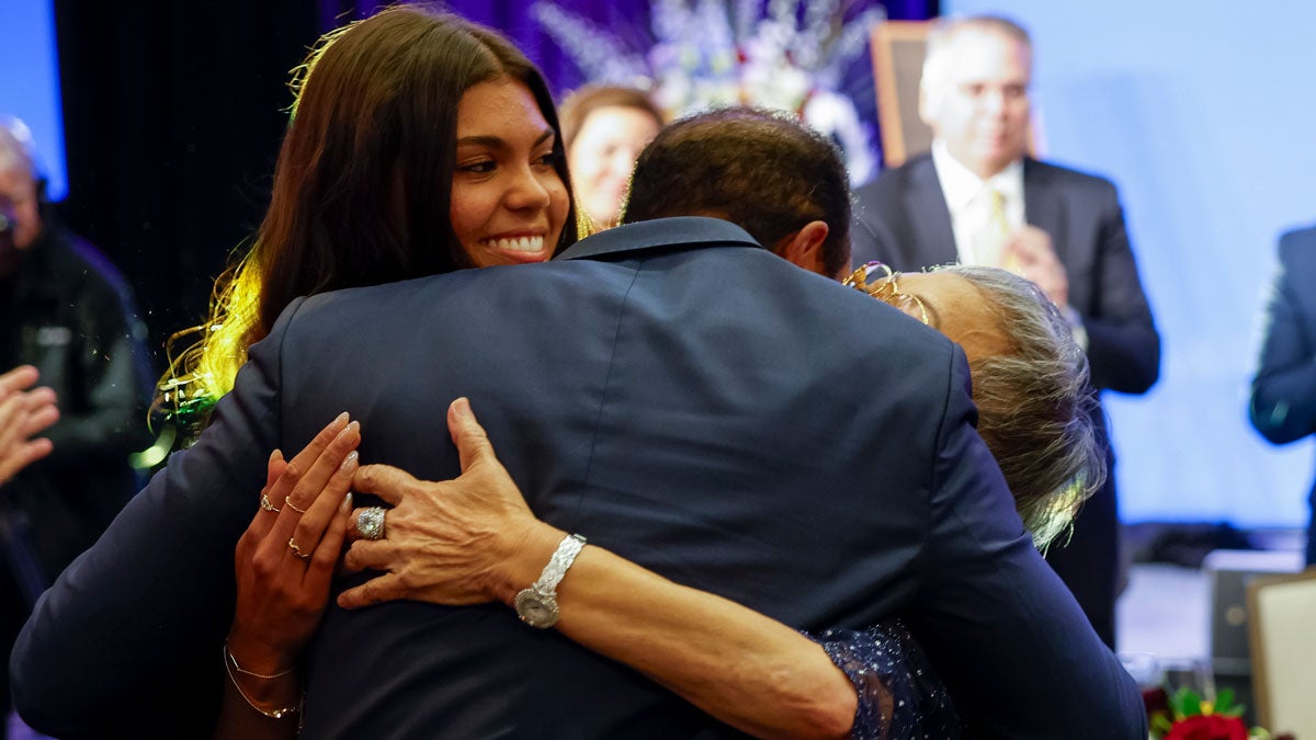 Tiger Woods hugs his mother Kultida Woods and daughter Sam Alexis Woods after receiving the Bob Jones Award during a ceremony at the Carolina Hotel