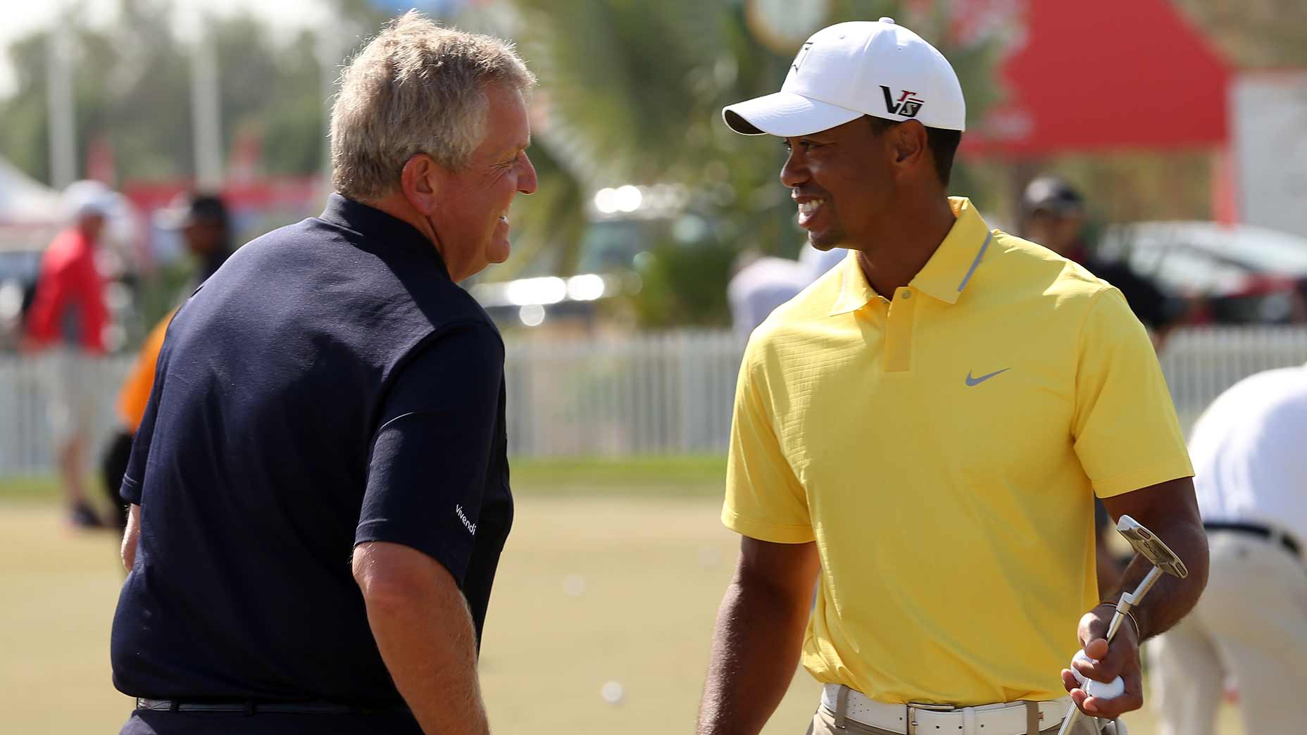Tiger Woods and Colin Montgomerie talk at the HSBC Golf Championship.