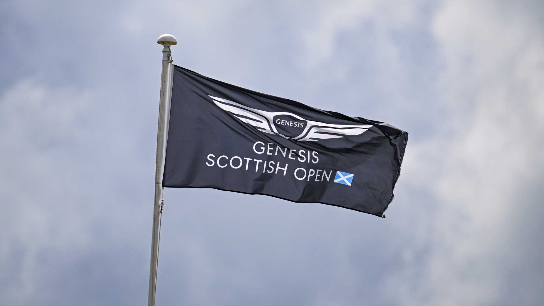 A Genesis Scottish Open flag against overcast sky