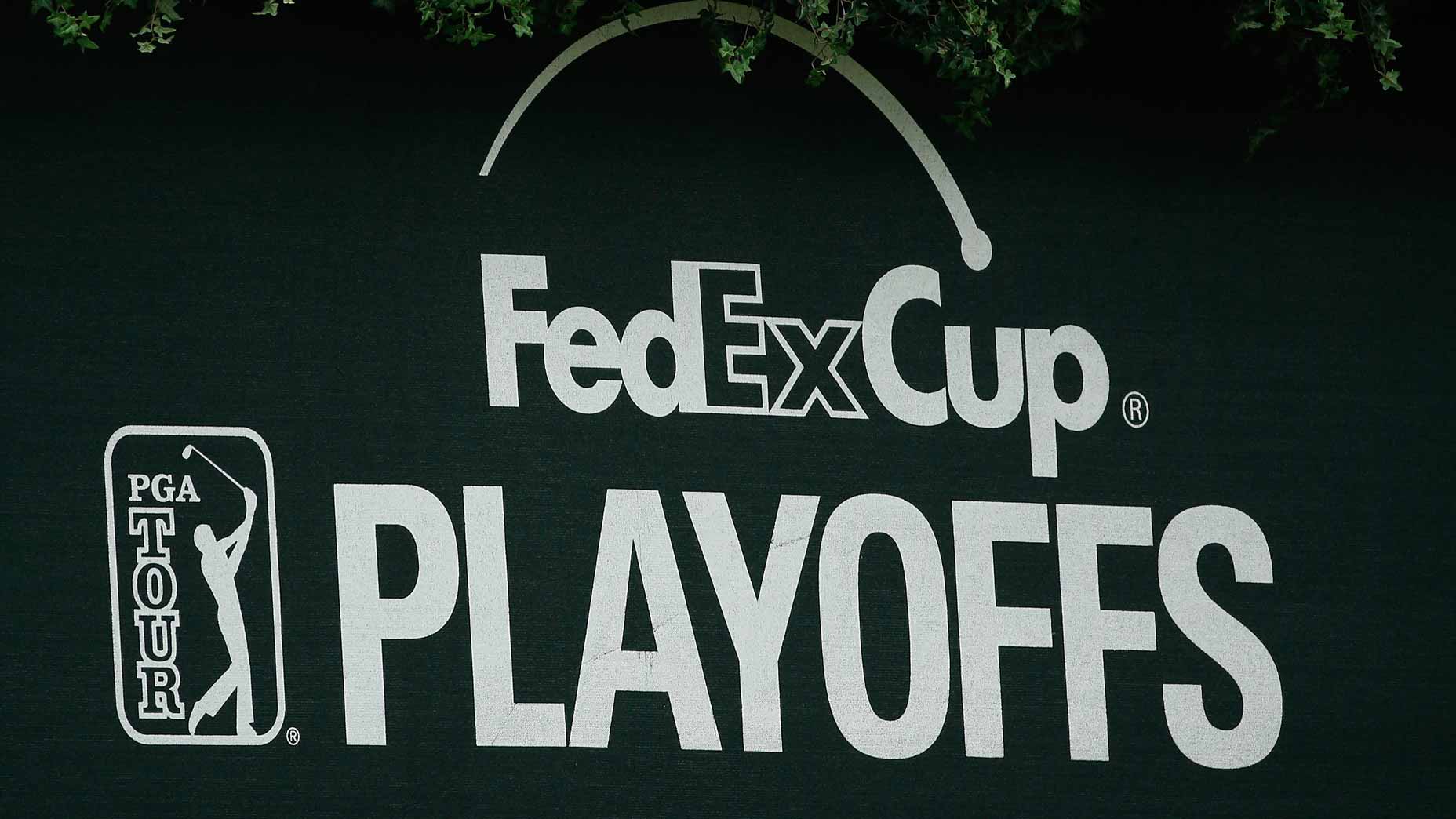 A green FedEx Cup Playoffs sign seen at a golf tournamet.