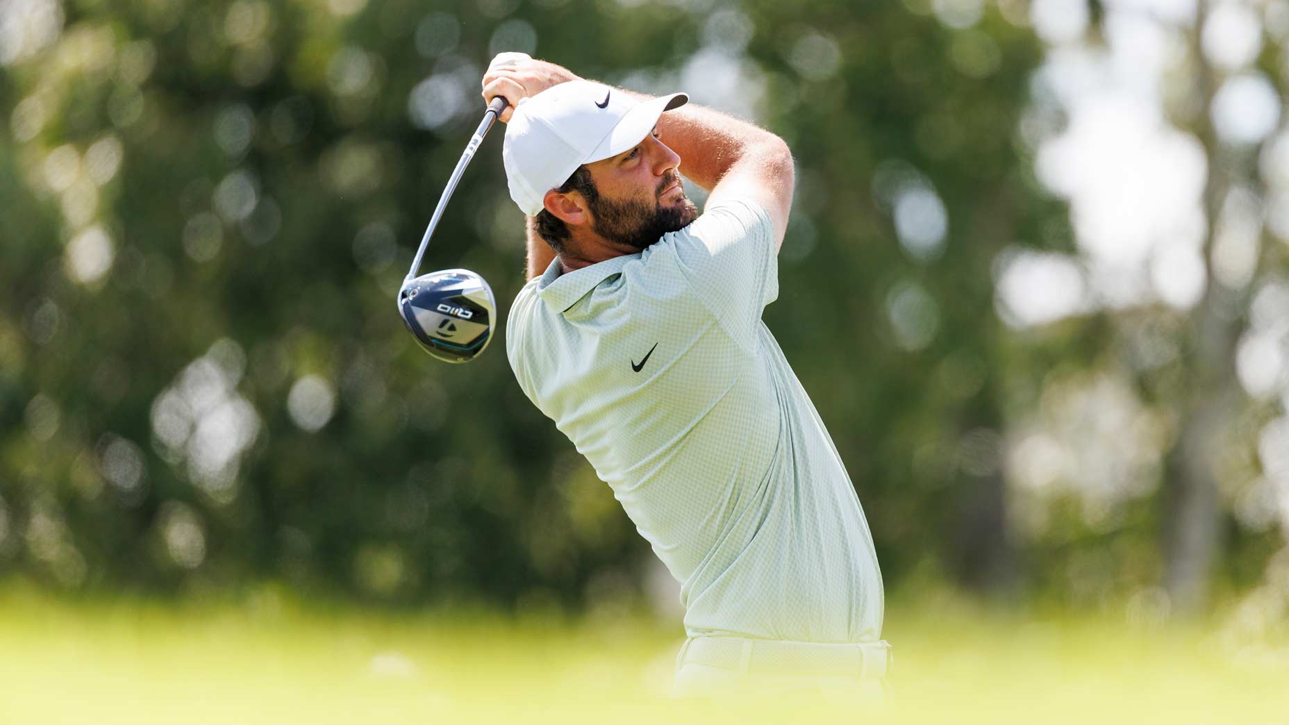 Pro golfer Scottie Scheffler hits shot during 2024 FedEx Cup Playoffs.