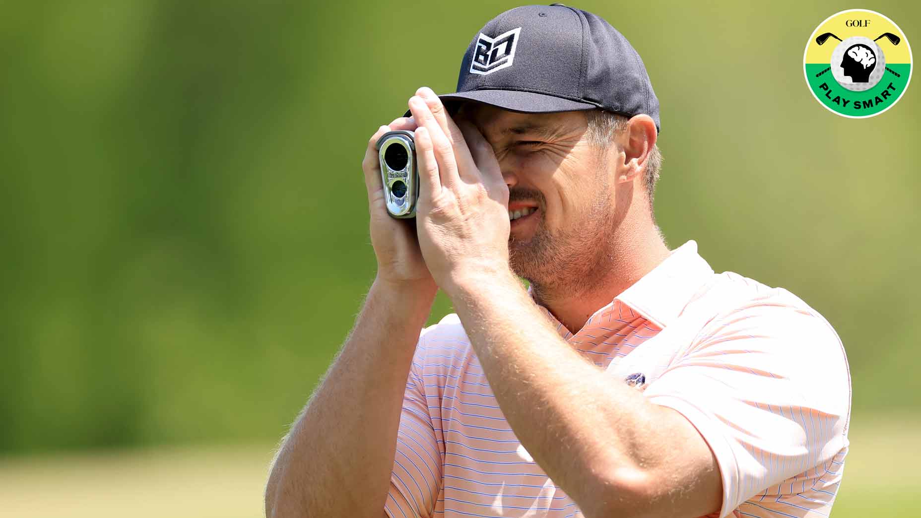 Pro golfer bryson decahmbeau uses a rangefinder during the 2023 pga championship
