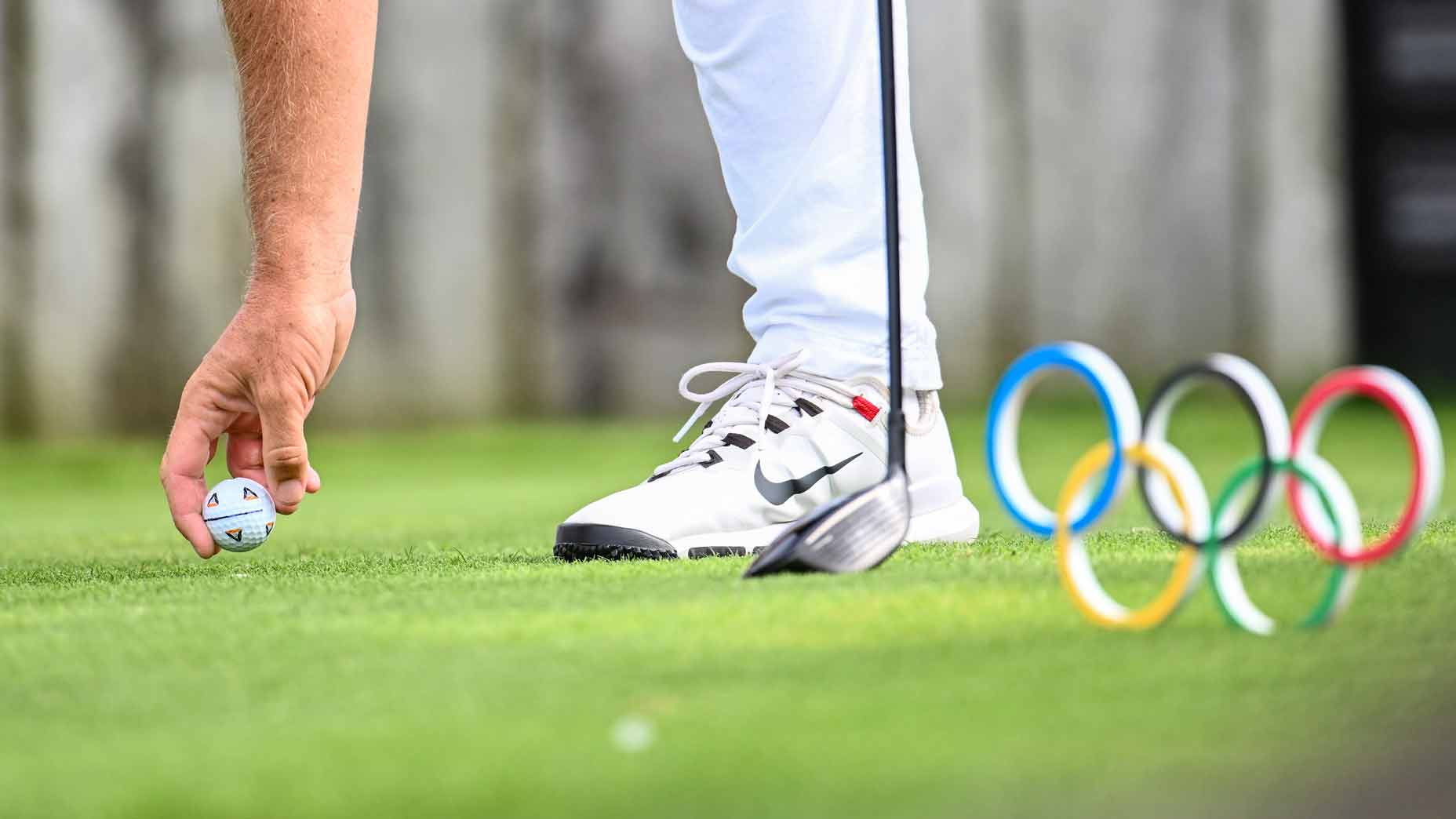tommy fleetwood tees up ball during the olympics