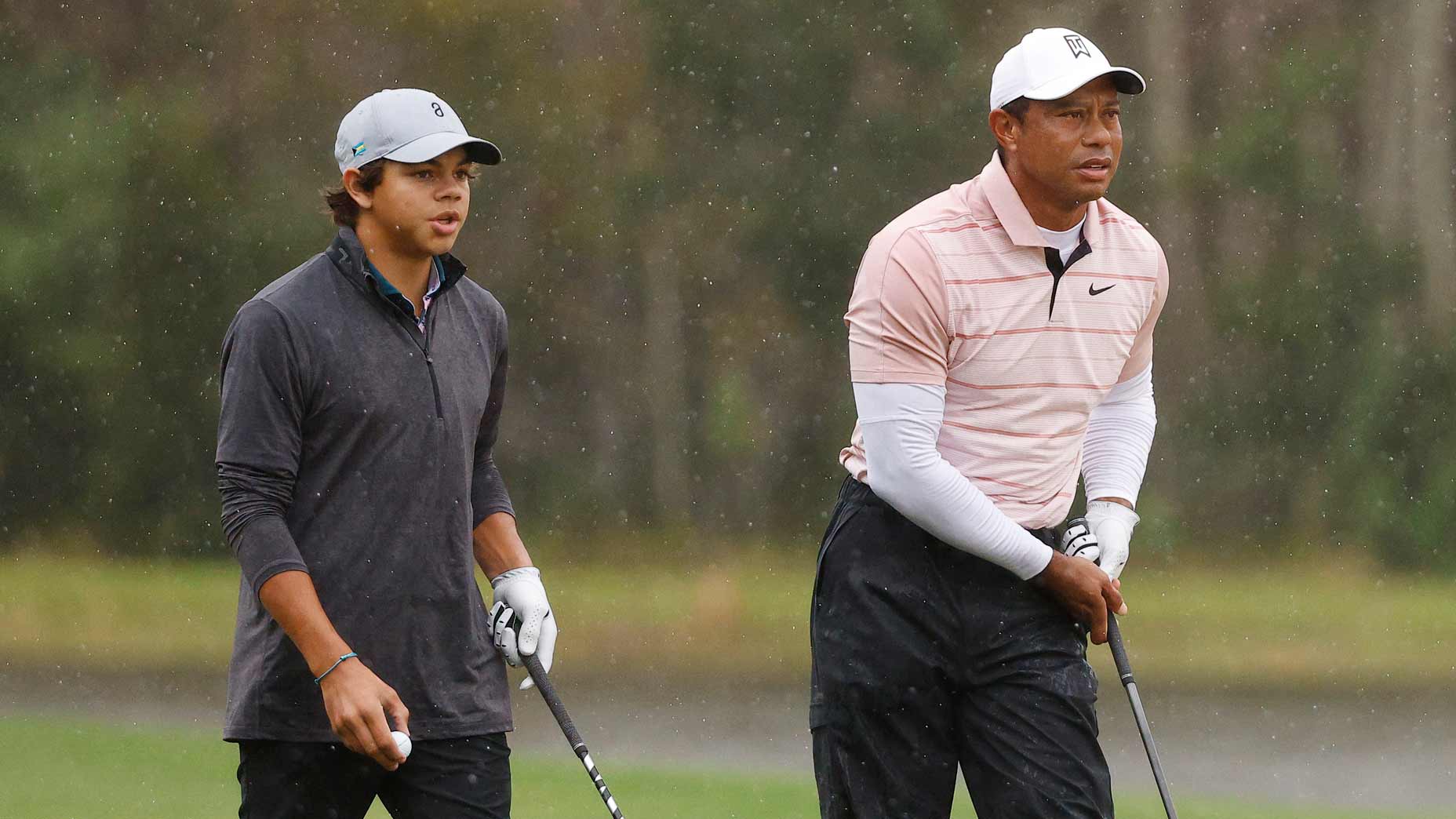 Tiger Woods and son Charlie Woods look on from the 14th hole during the first round of the PNC Championship at The Ritz-Carlton Golf Club.