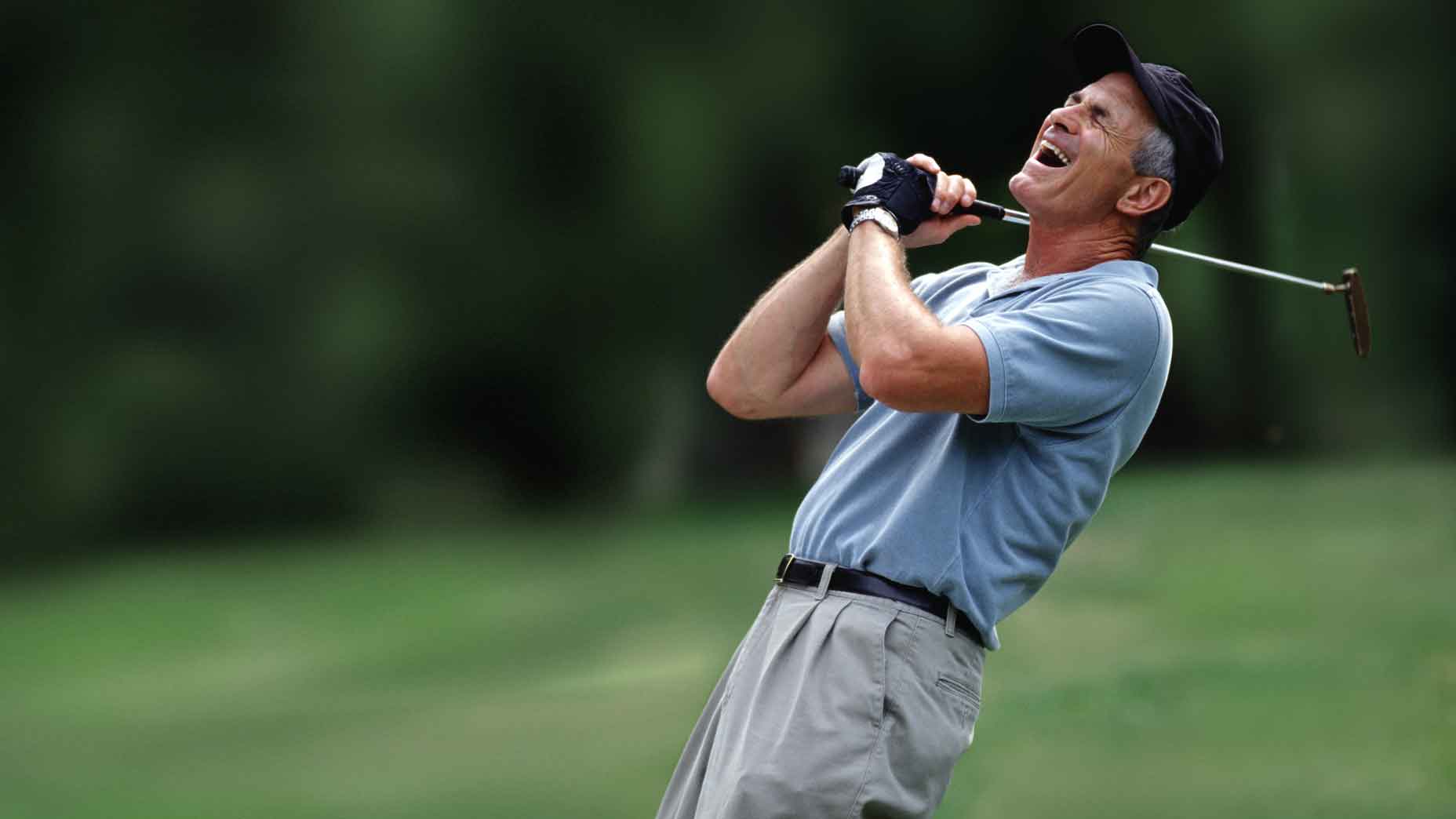 golfer in blue shirt is frustrated