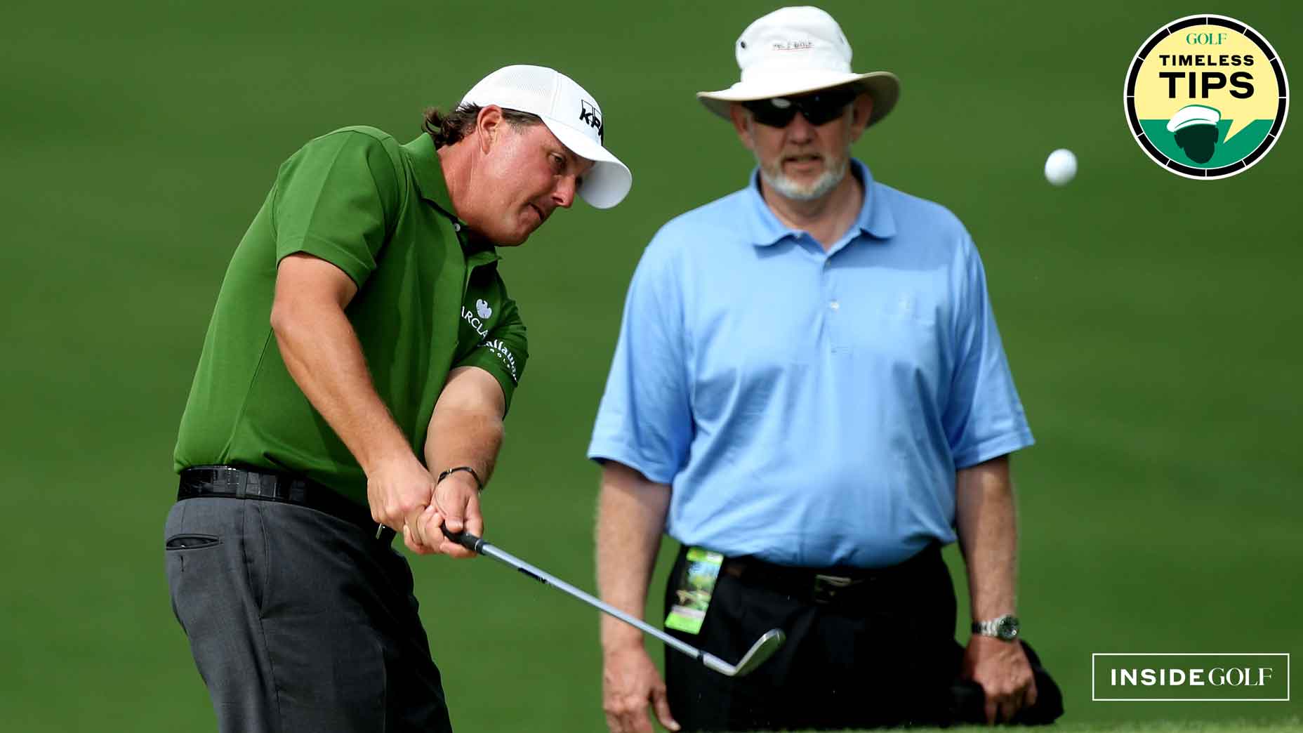 dave pelz looks on as phil mcikelson hits a chip in preparation for the 2008 masters
