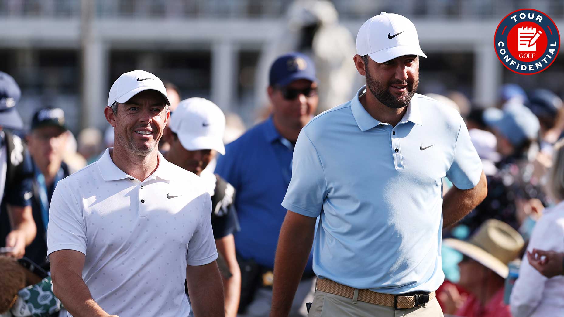 scottie scheffler and rory mcilroy walk at the players championship next to a tour confidential logo