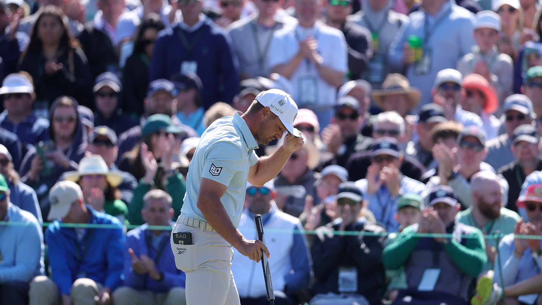 Bryson DeChambeau tips his cap to patrons during the second round of the Masters.