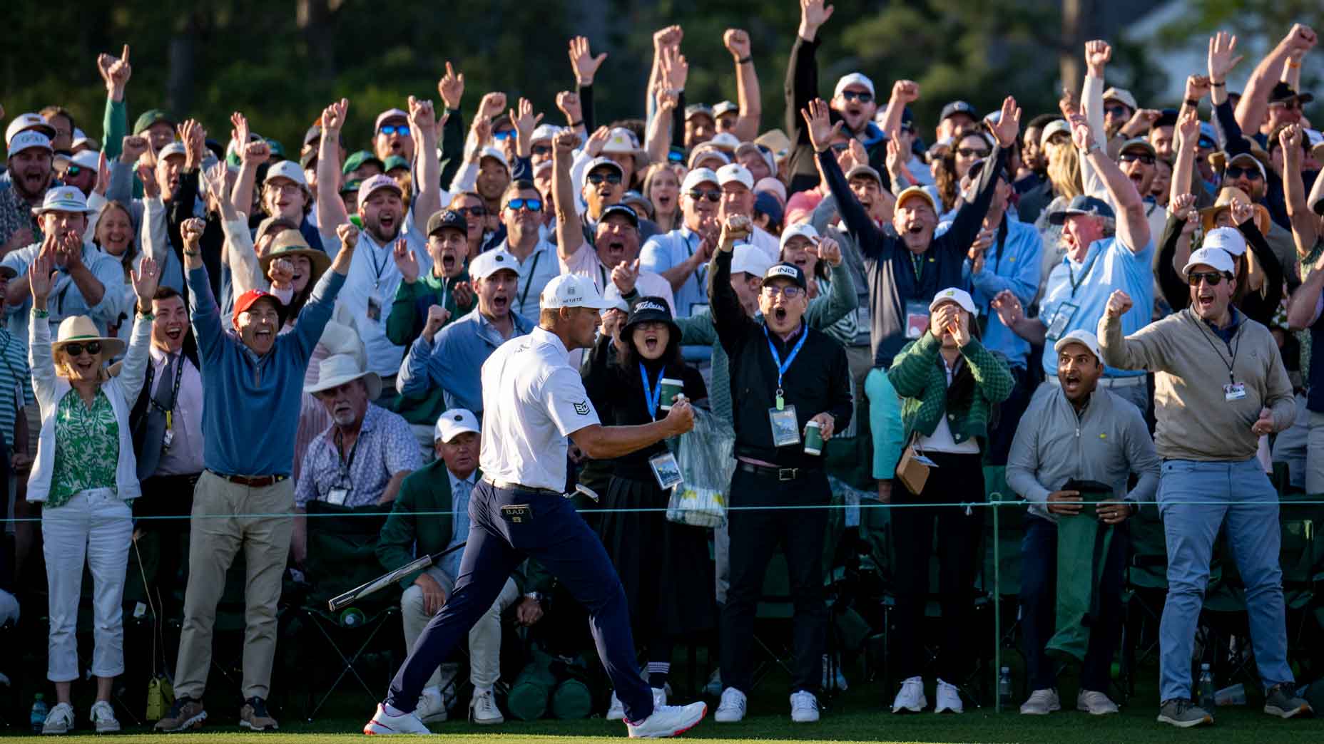 Bryson DeChambeau celebrates with the Masters patrons after a birdie on the No. 18 green during the third round of the 2025 Masters at Augusta National Golf Club.