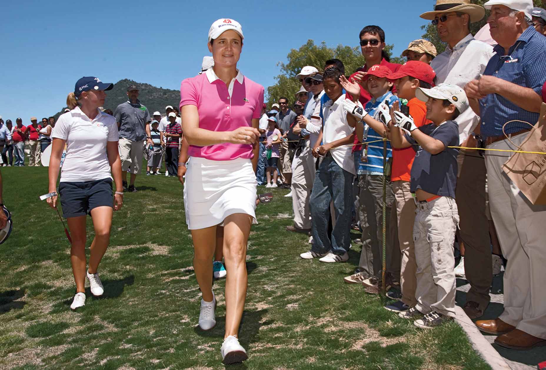 Lorena Ochoa walks by fans at the 2010 Tres Marias Championship in Morelia, Mexico.