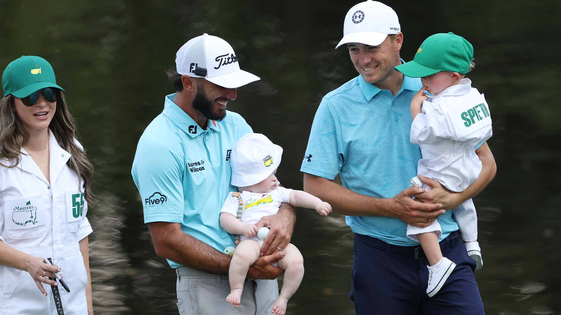 Max Homa and Jordan Spieth hold their sons on the ninth green during the Masters Par 3 contest in 2023