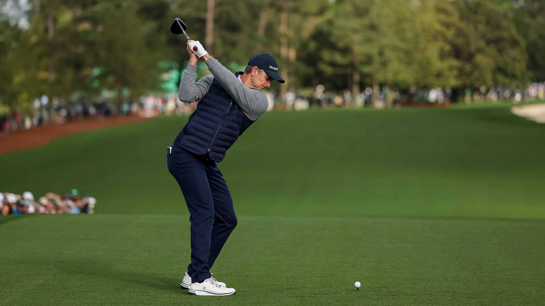 Justin Rose, who will have a late Masters tee time on Saturday, plays his shot from the first tee during the second round of the 2025 Masters.