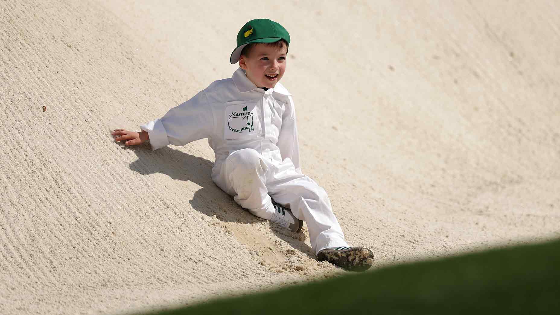 Son of Nick Taylor of Canada, Charlie Taylor, plays in a bunker during the Par Three Contest prior to the 2025 Masters Tournament at Augusta National Golf Club on April 09, 2025 in Augusta, Georgia.