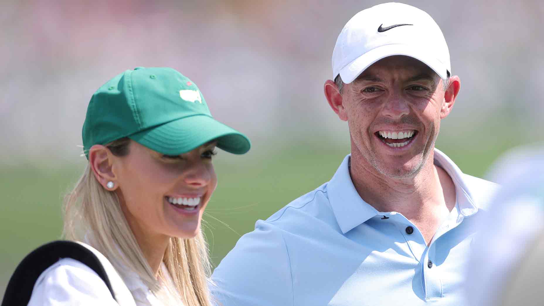 Rory McIlroy of Northern Ireland reacts with wife Erica Stoll during the Par Three Contest prior to the 2025 Masters Tournament at Augusta National Golf Club on April 09, 2025 in Augusta, Georgia. (