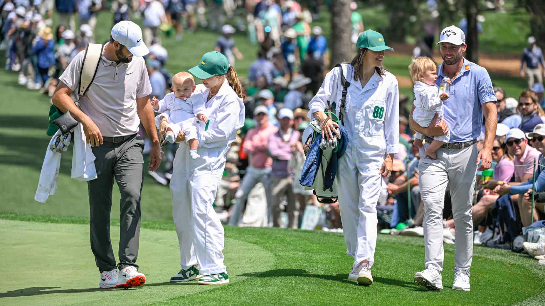 cottie Scheffler, his wife Meredith Scheffler and their son Bennett walk with Sam Burns, Caroline Campbell and their son Bear during the Par Three Contest prior to the Masters Tournament at Augusta National Golf Club on April 9, 2025 in Augusta, Georgia.