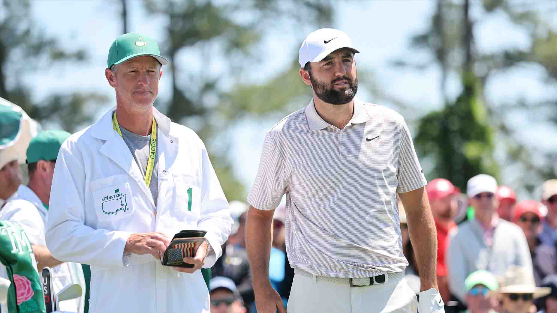 PGA Tour pro Scottie Scheffler and caddie Ted Scott survey a hole during the 2025 Masters.