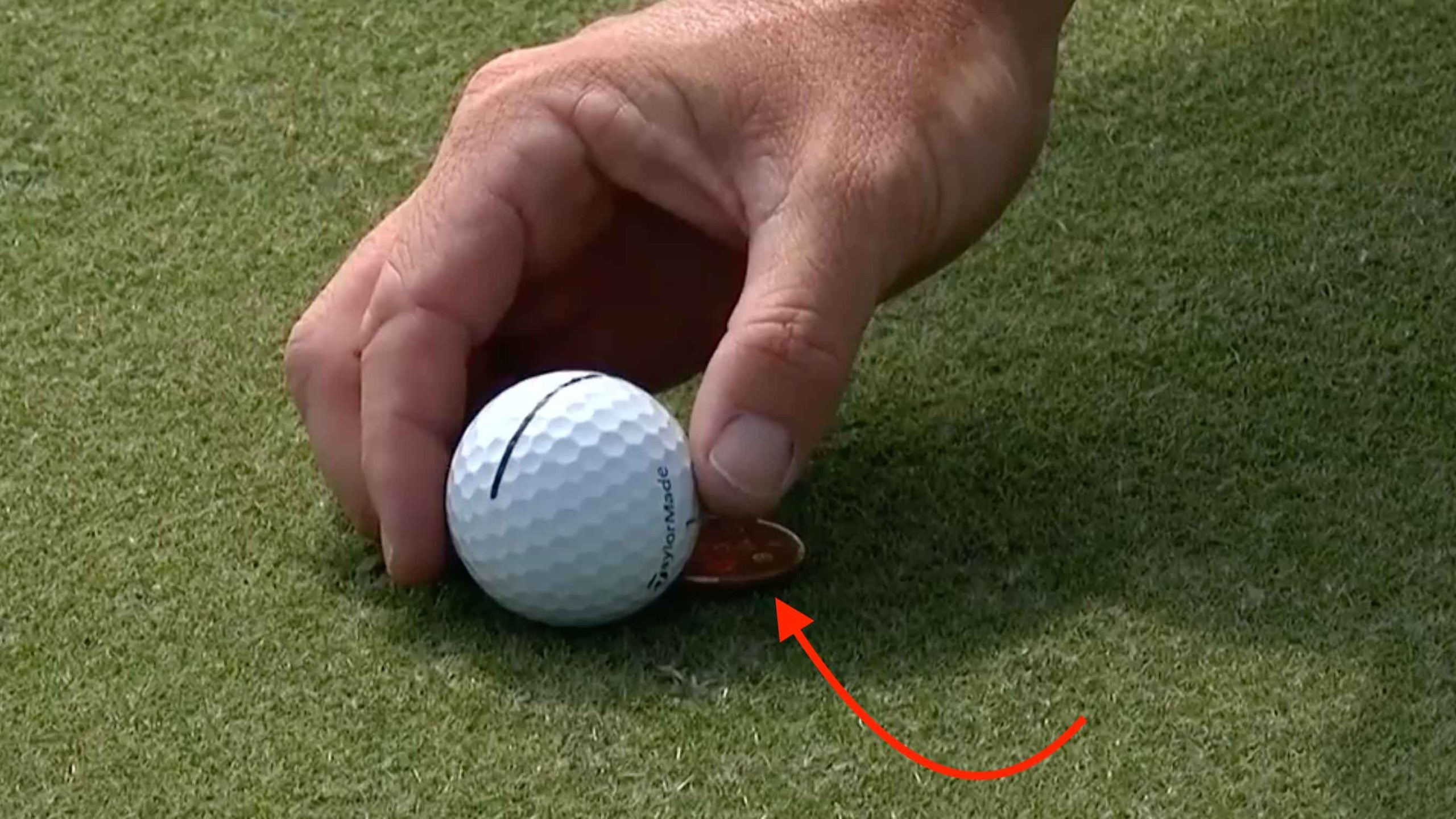rory mcilroy marking his ball on the green