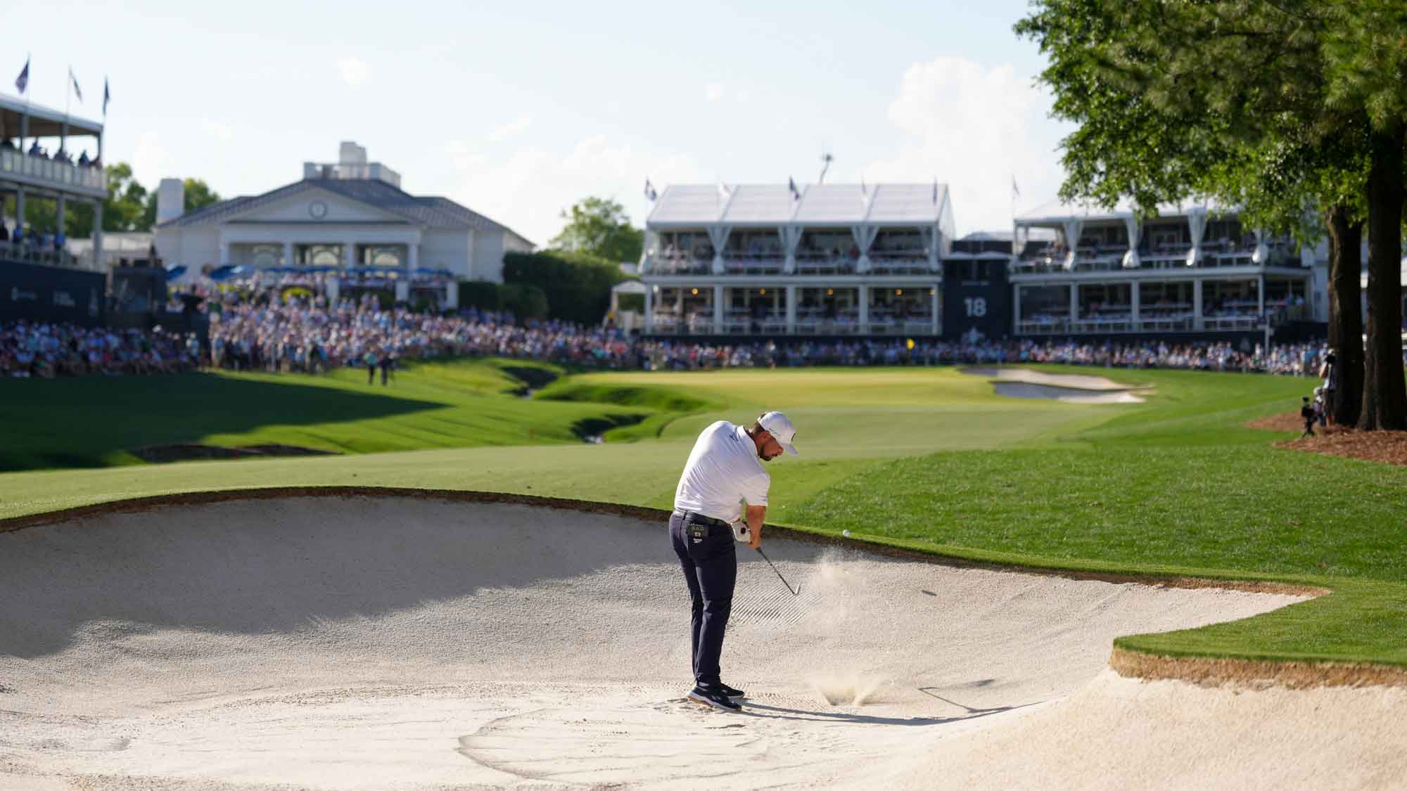 Bryson DeChambeau hits out of the bunker on the 18th hole during the third round of the PGA Championship at Quail Hollow Club