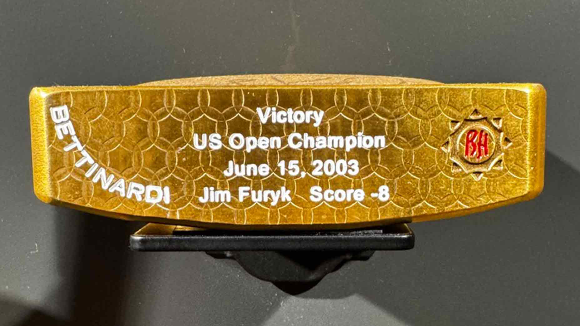 A gold replica of Jim Furyk's 2003 U.S. Open-winning Bettinardi putter.
