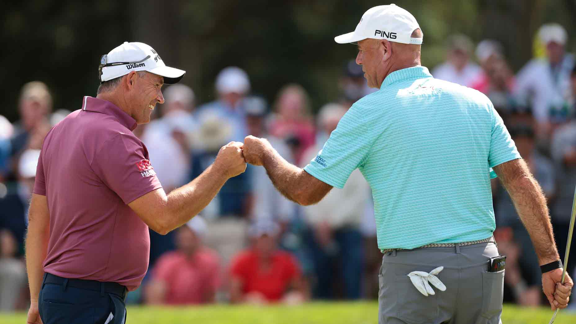 Padraig Harrington of Ireland and Stewart Cink of the United States fist bump on the 18th green during the third round of the U.S. Senior Open Championship 2025 at Broadmoor Golf Club on June 28, 2025 in Colorado Springs, Colorado.