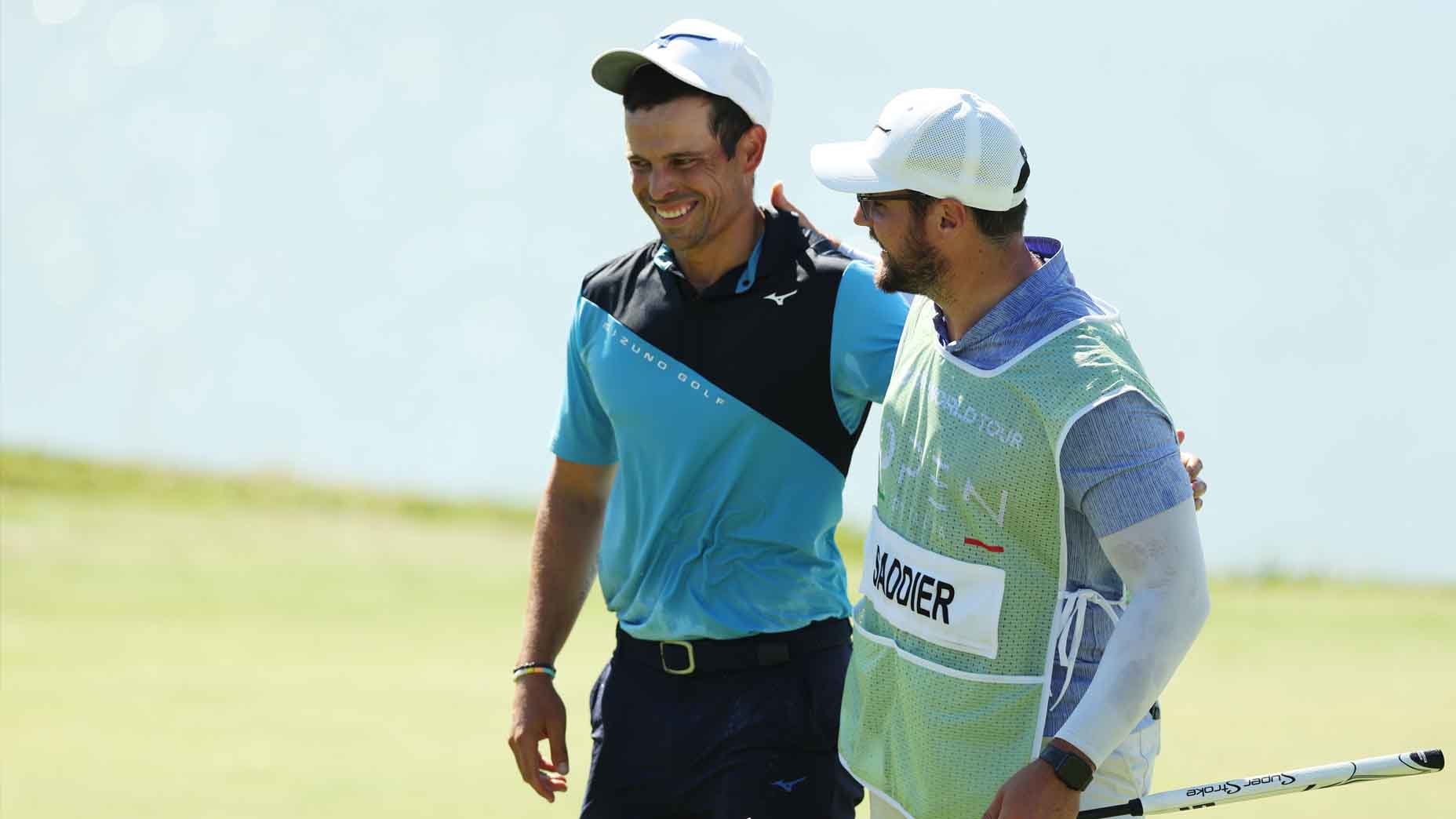 Adrien Saddier and his caddie walk off the 18th green at the Italian Open