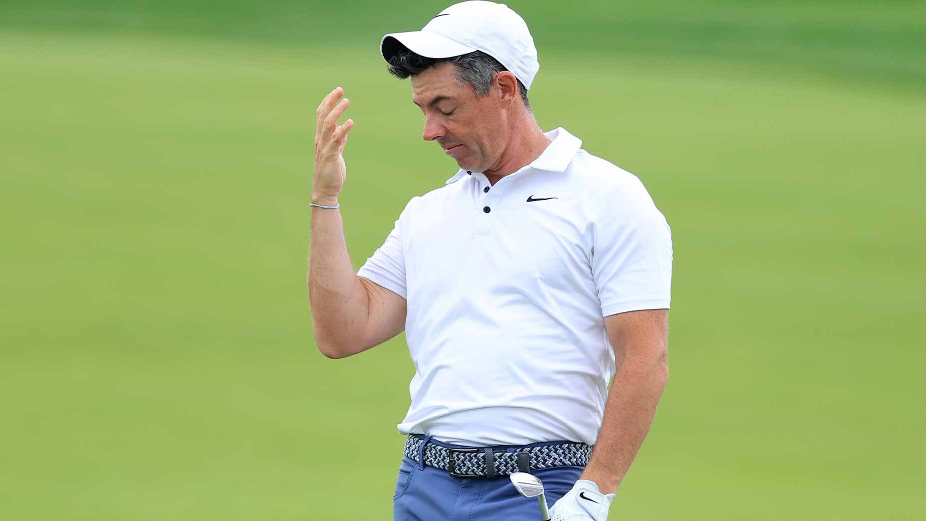 rory mcilroy pushes hat off head in white shirt at the u.s. open