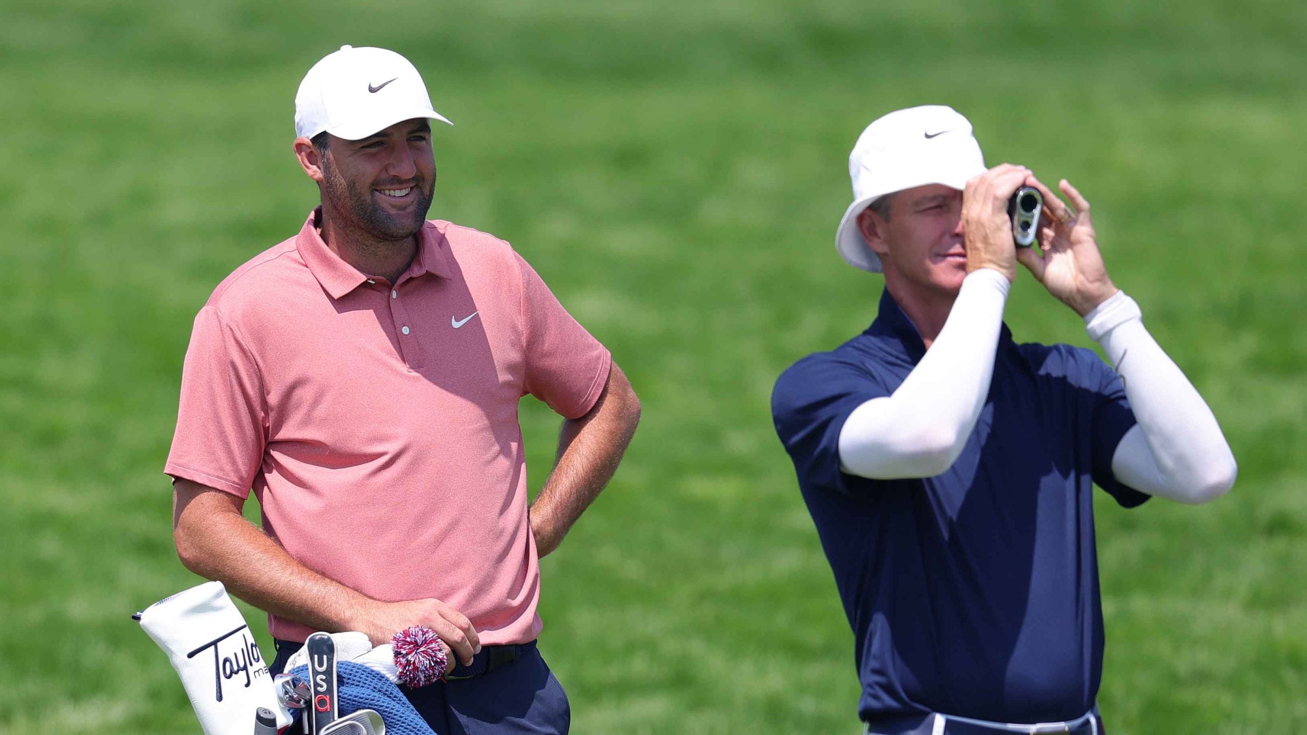 Scottie Scheffler of the United States and caddie Ted Scott line up a shot on the 10th hole during a practice round prior to the 125th U.S. OPEN