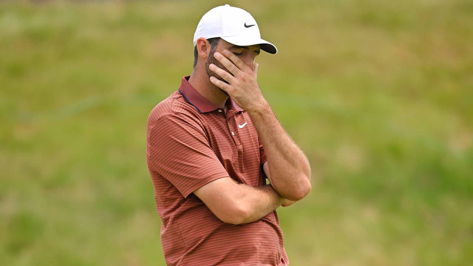 PGA Tour pro Scottie Scheffler covers his face during the 2025 U.S. Open at Oakmont.