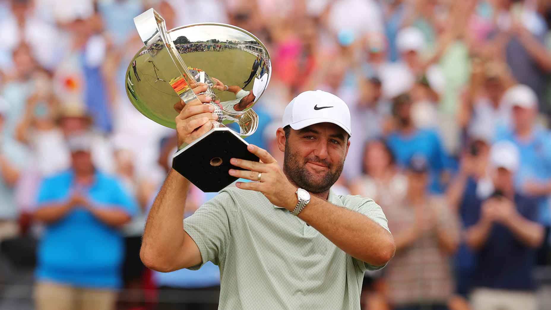 Scottie Scheffler hold FedEx Cup trophy.
