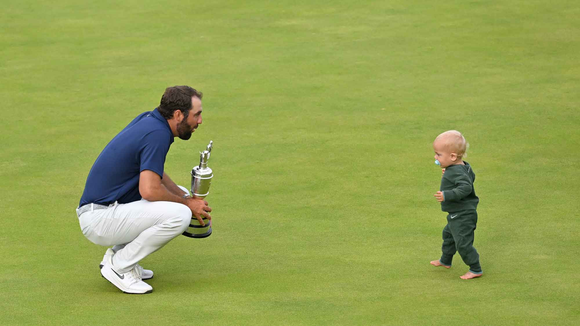 scottie Scheffler of the United States plays with his son, Bennett Scheffler, on the 18th green, during the final round of The Open Championship