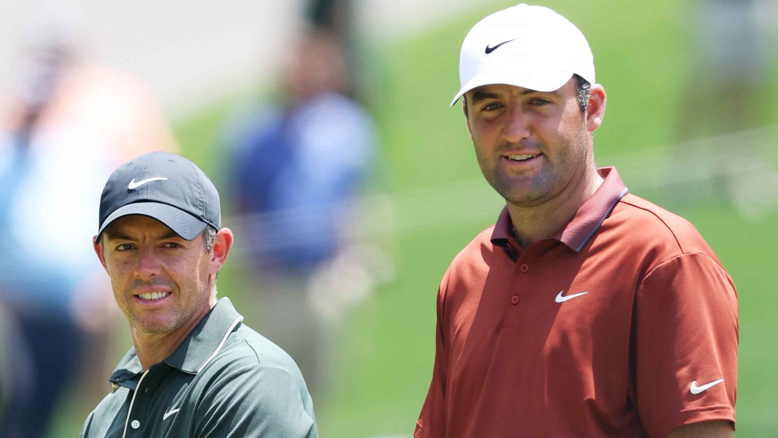 Rory McIlroy of Northern Ireland and Scottie Scheffler of the United States talk as they walk the 7th fairway during the first round of the PGA Championship