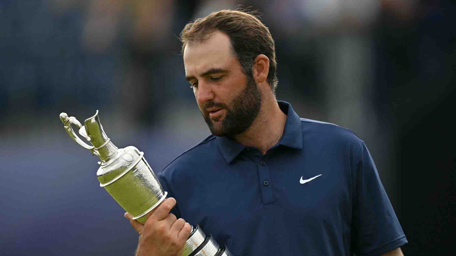 Scottie Scheffler looks at the Claret Jug