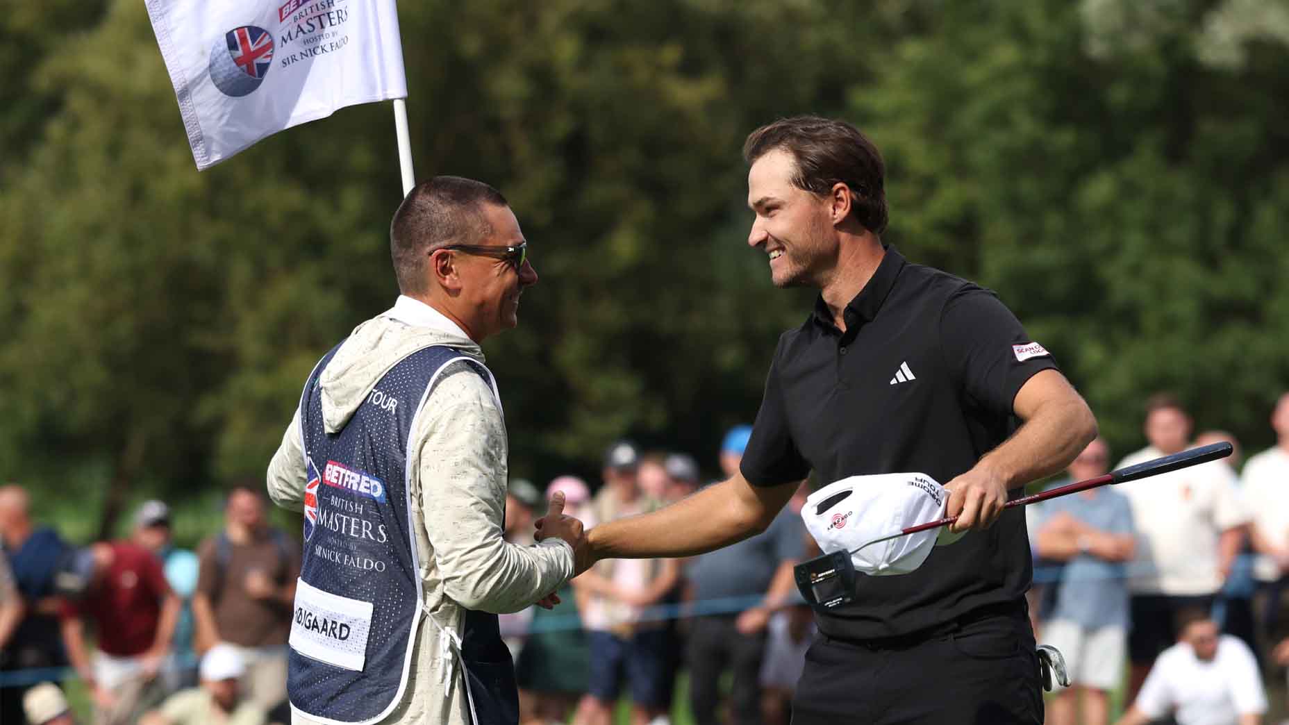 Rasmus Hojgaard embraces his caddie after qualifying for the European Ryder Cup team